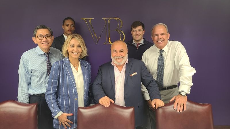 Anthony Viscogliosi standing with members of the Companion Spine team in the New York Viscogliosi Brothers office