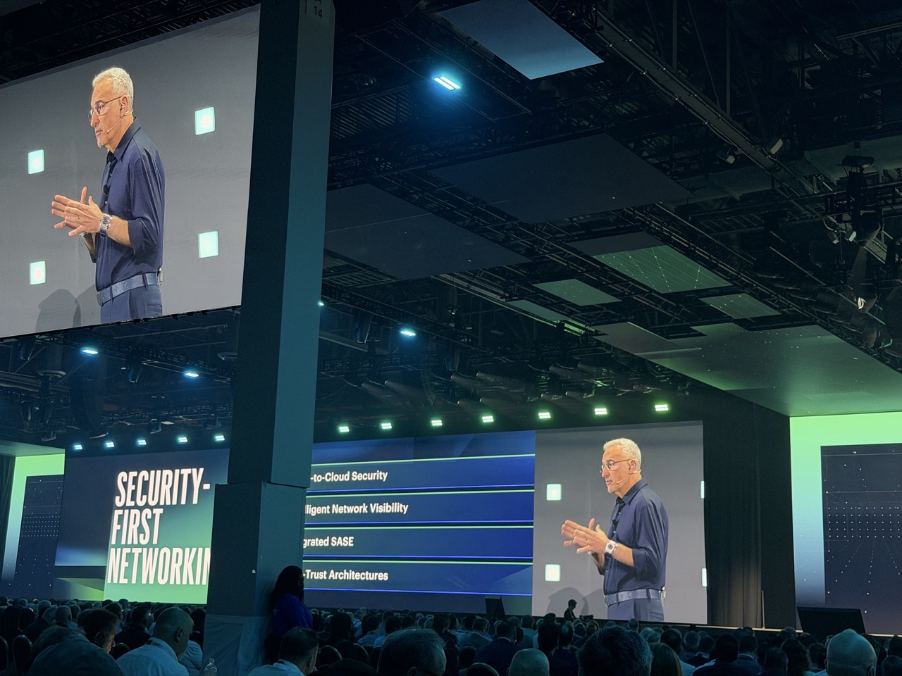 Antonio Neri appears on large screens during his HPE Discover 2026 keynote in Las Vegas, with networking topics behind him.