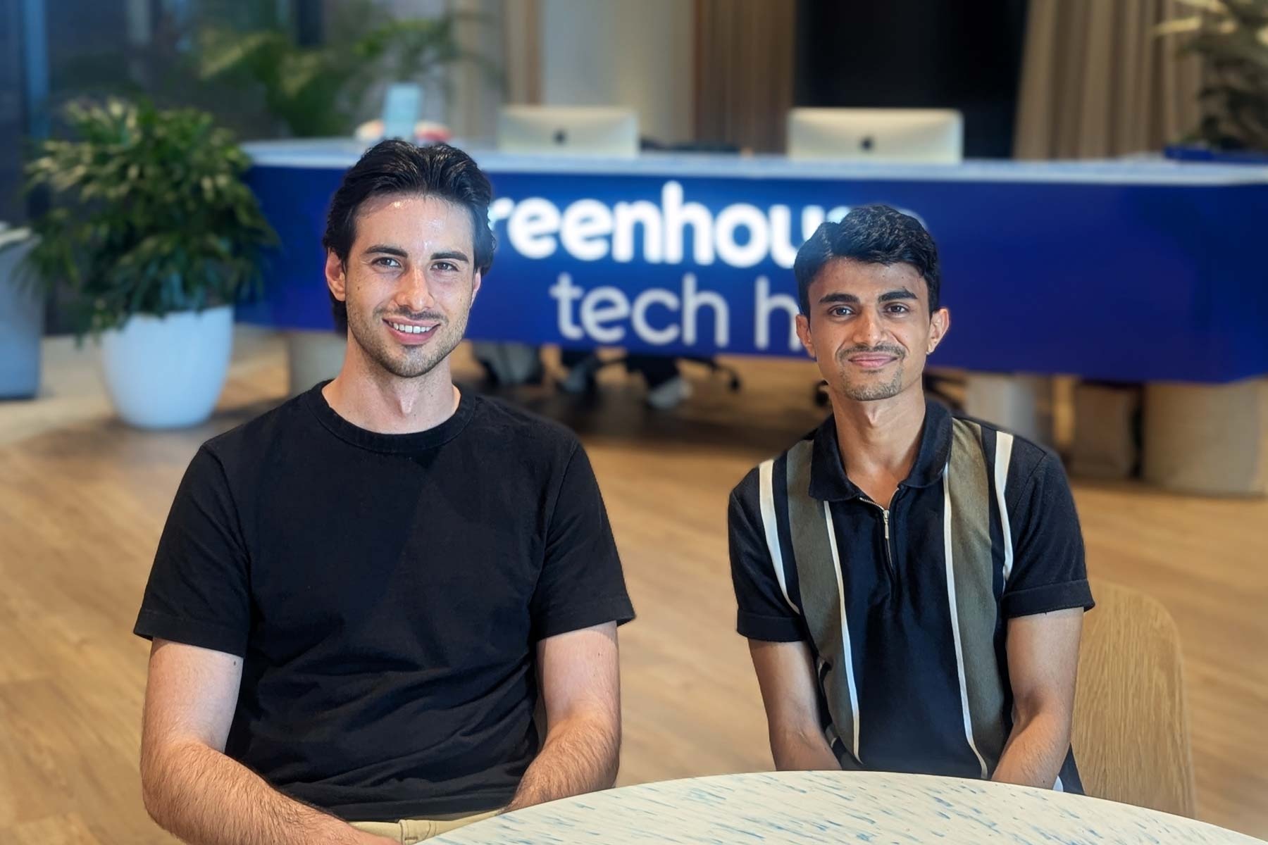 Misha Cajic, left, and Anuj Paudel, right, seated at Greenhouse Tech Hub