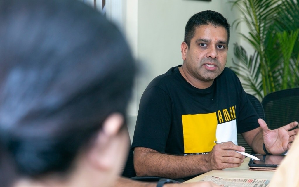 Anupam Nandwana discussing ideas across a table during a P360 client brainstorming session