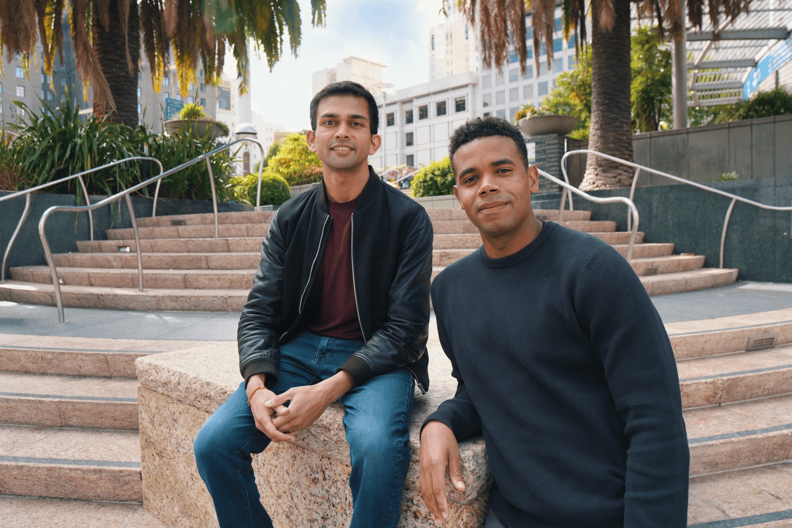 Anything founders seated outdoors in an urban courtyard