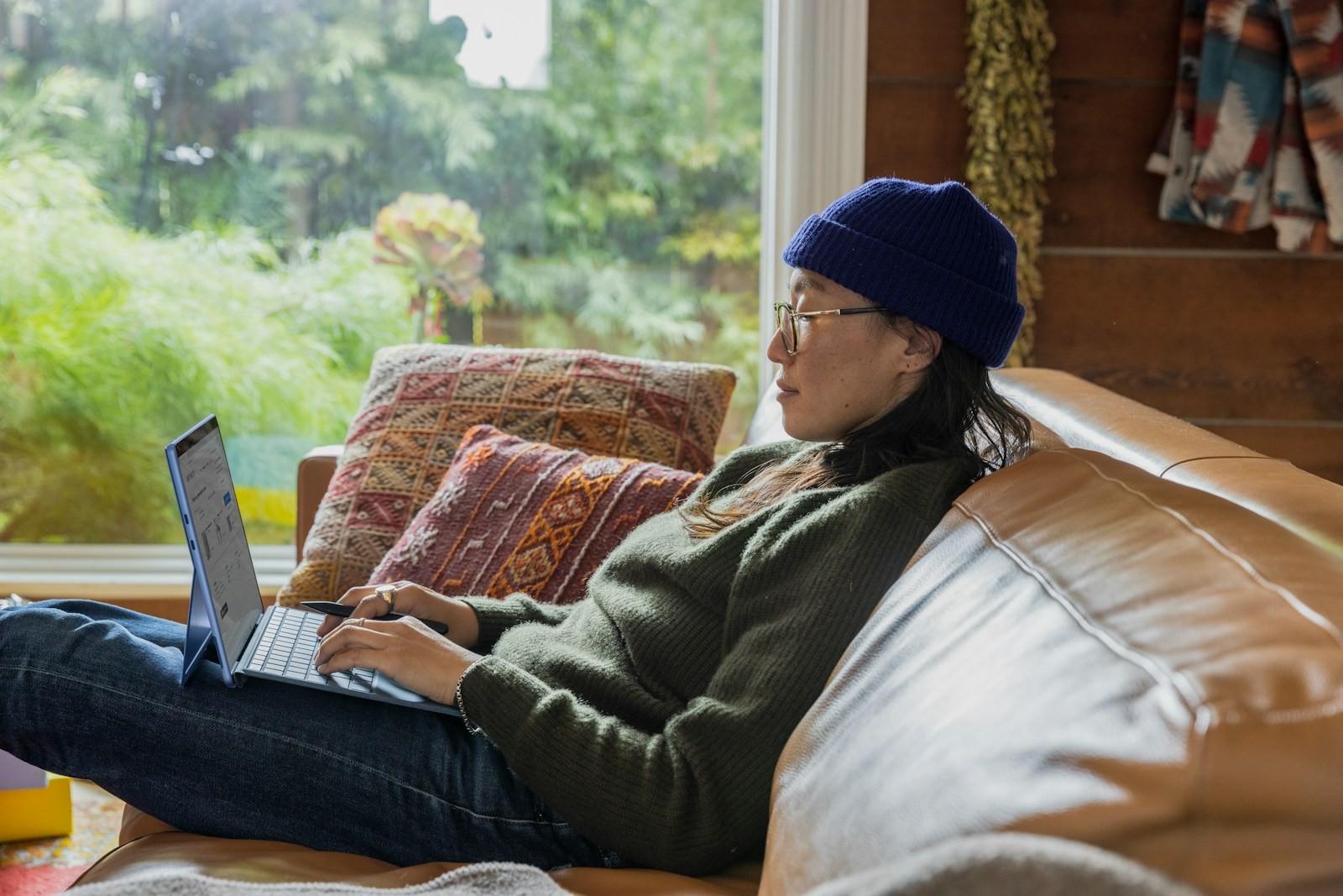 A person working at a laptop at a table