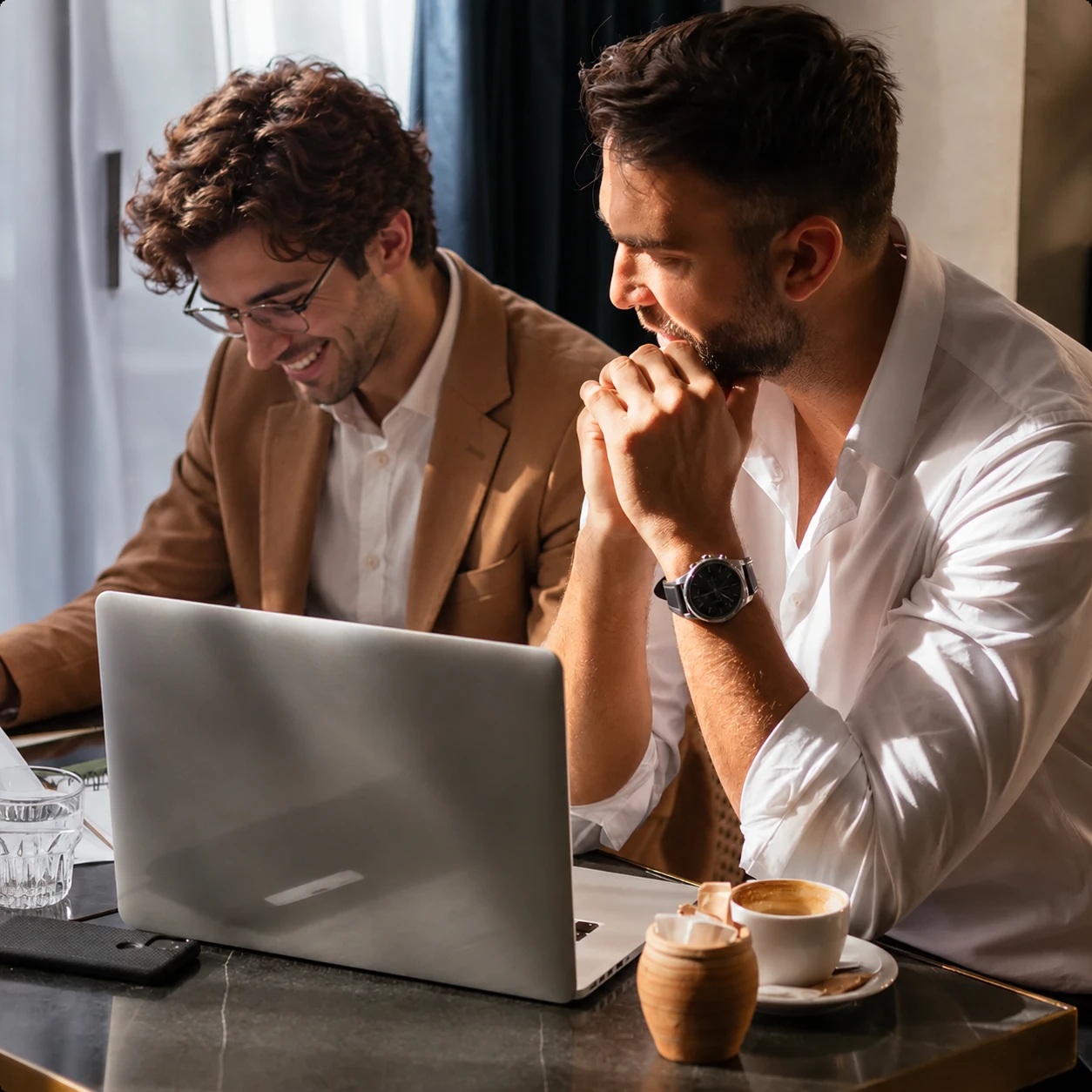 Two people reviewing a laptop in imagery published on Apex’s website
