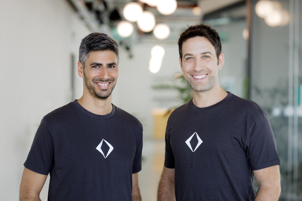 Apiiro founders Idan Plotnik and Yonatan Eldar standing together in an office