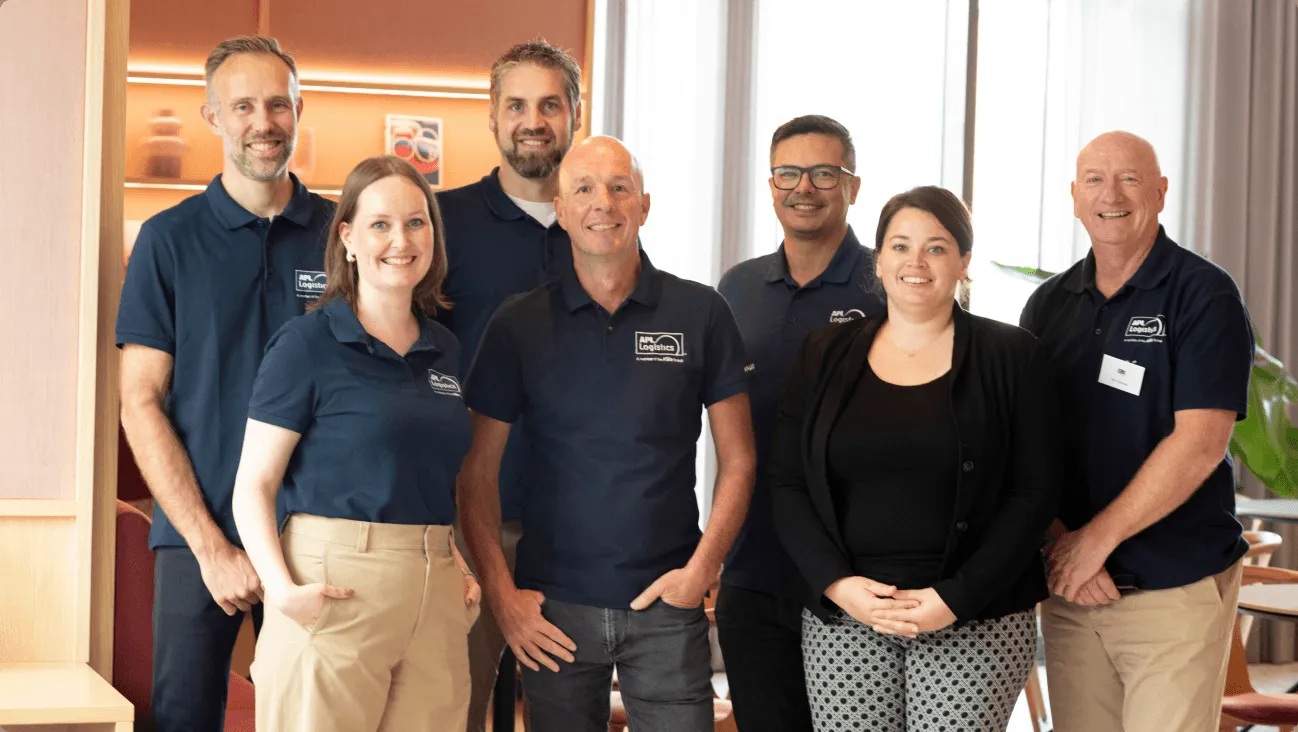 APL Logistics colleagues posing together in company polo shirts