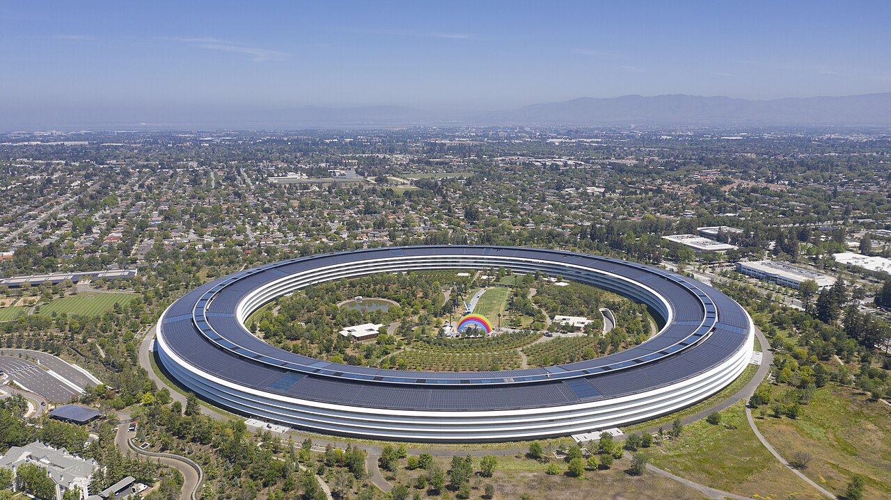 Aerial view of Apple Park, the circular headquarters building in Cupertino, surrounded by trees
