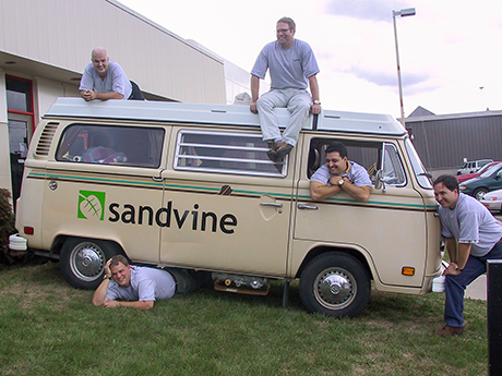 Sandvine’s five founders posing around a branded Volkswagen van on launch day in 2001