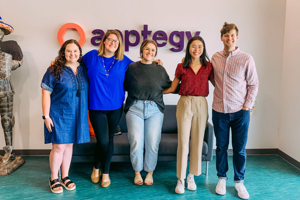 Five Apptegy employees standing together in the company's Little Rock office