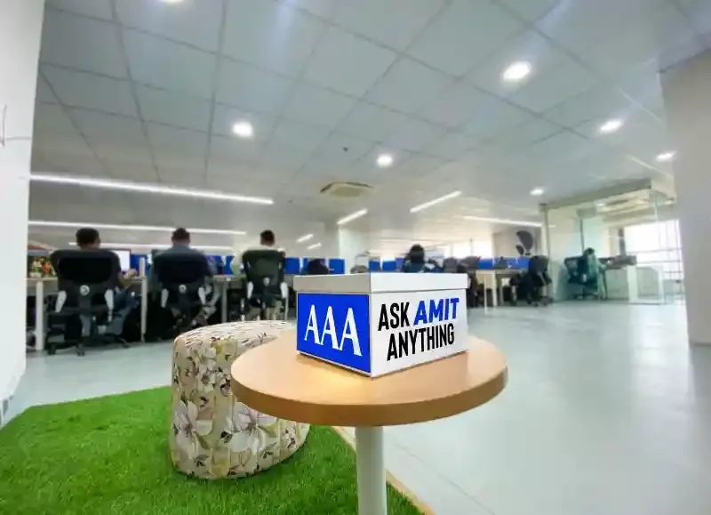 An Ask Amit Anything question box on a table in AQe Digital’s open office