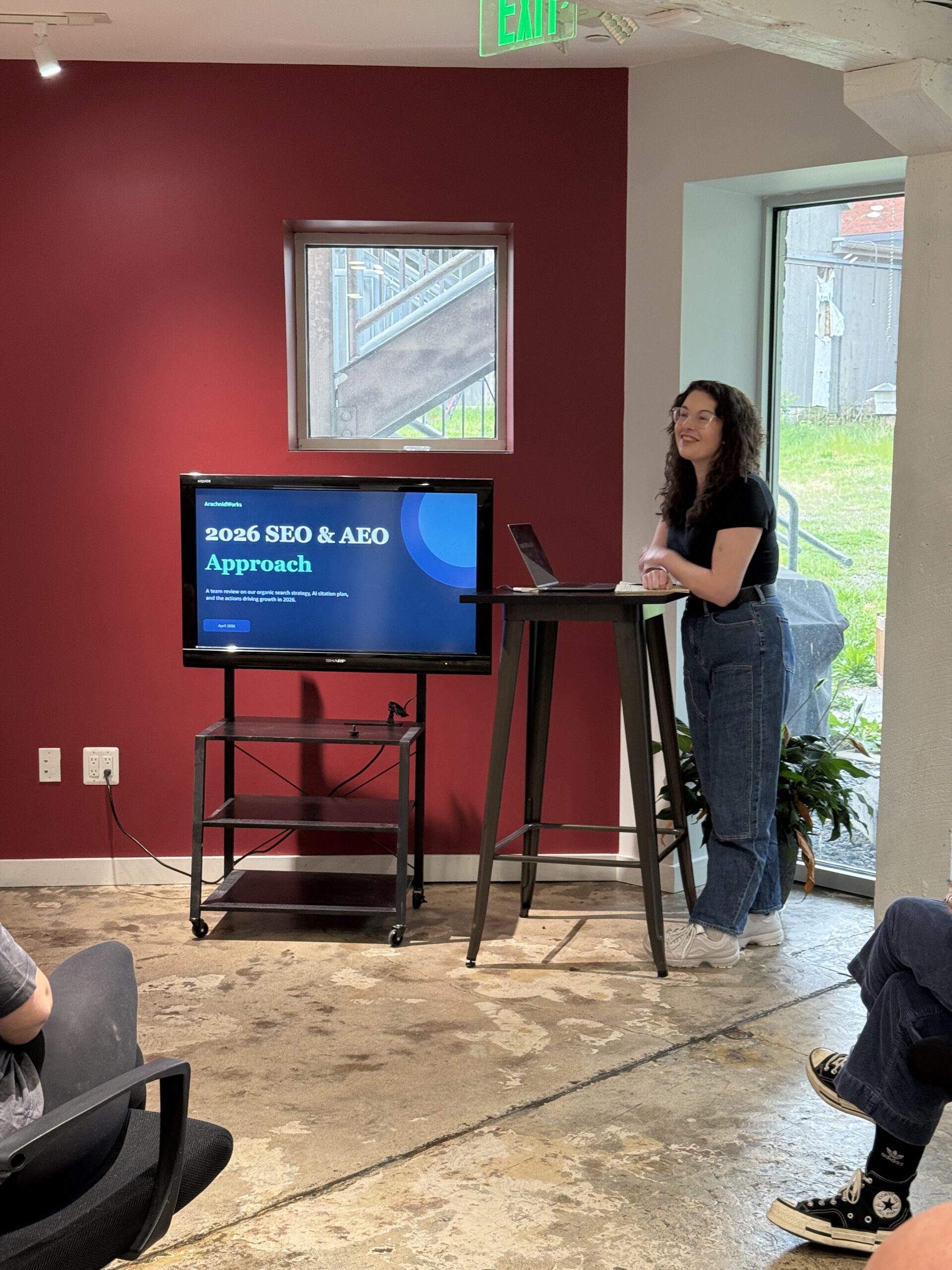 An ArachnidWorks team member presents an SEO and AEO plan in the Frederick office