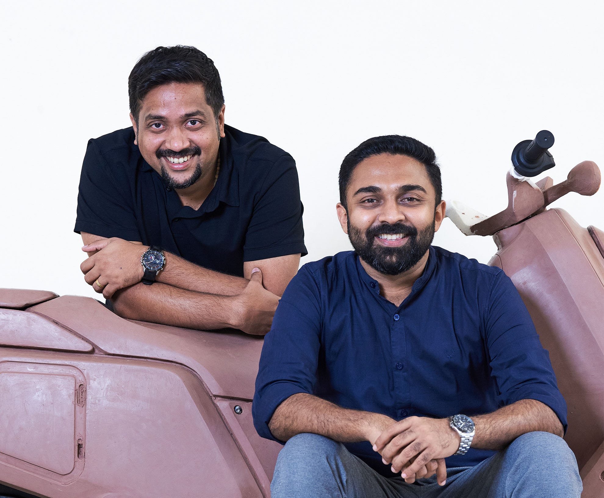 Vipin George on the left and Aravind Mani on the right, beside an early clay scooter model