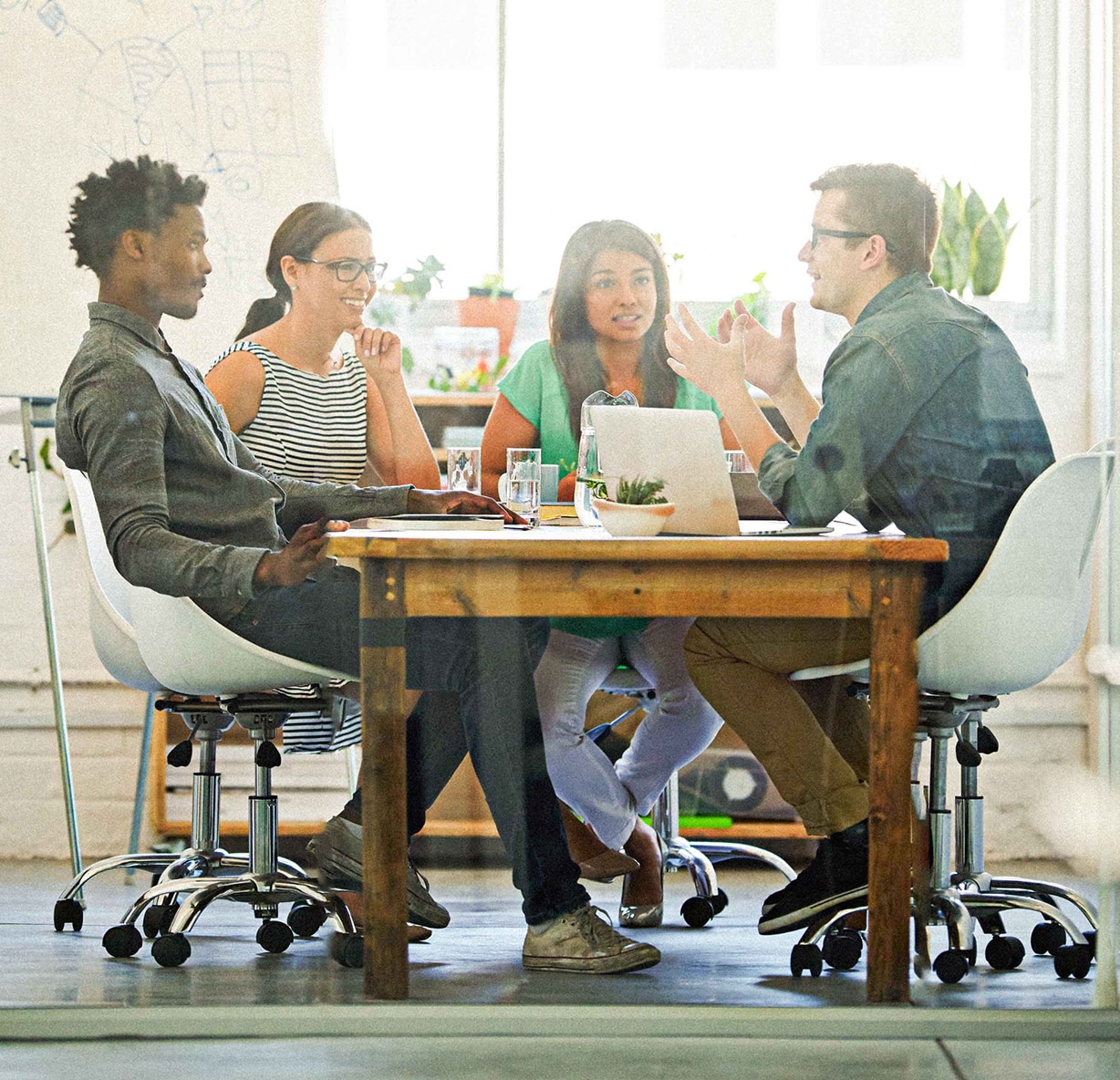 People meeting around a table in an image published on Arbiter’s about page
