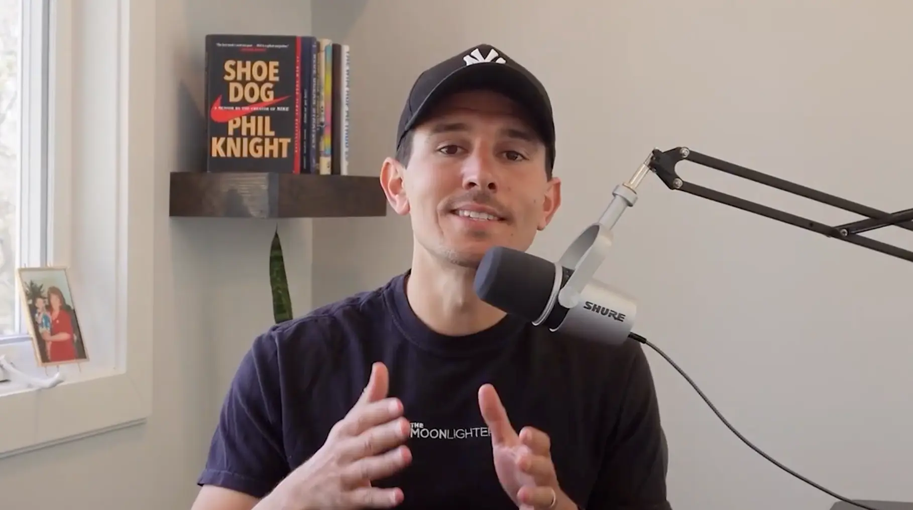 A creator speaking beside a microphone in a video featured on the Arcads website