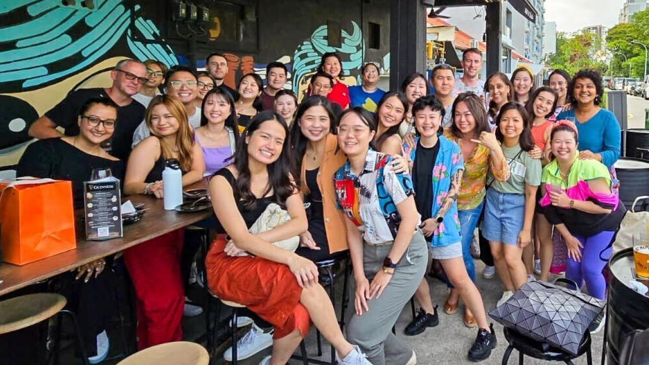 Archetype colleagues gathered outside a colorful venue