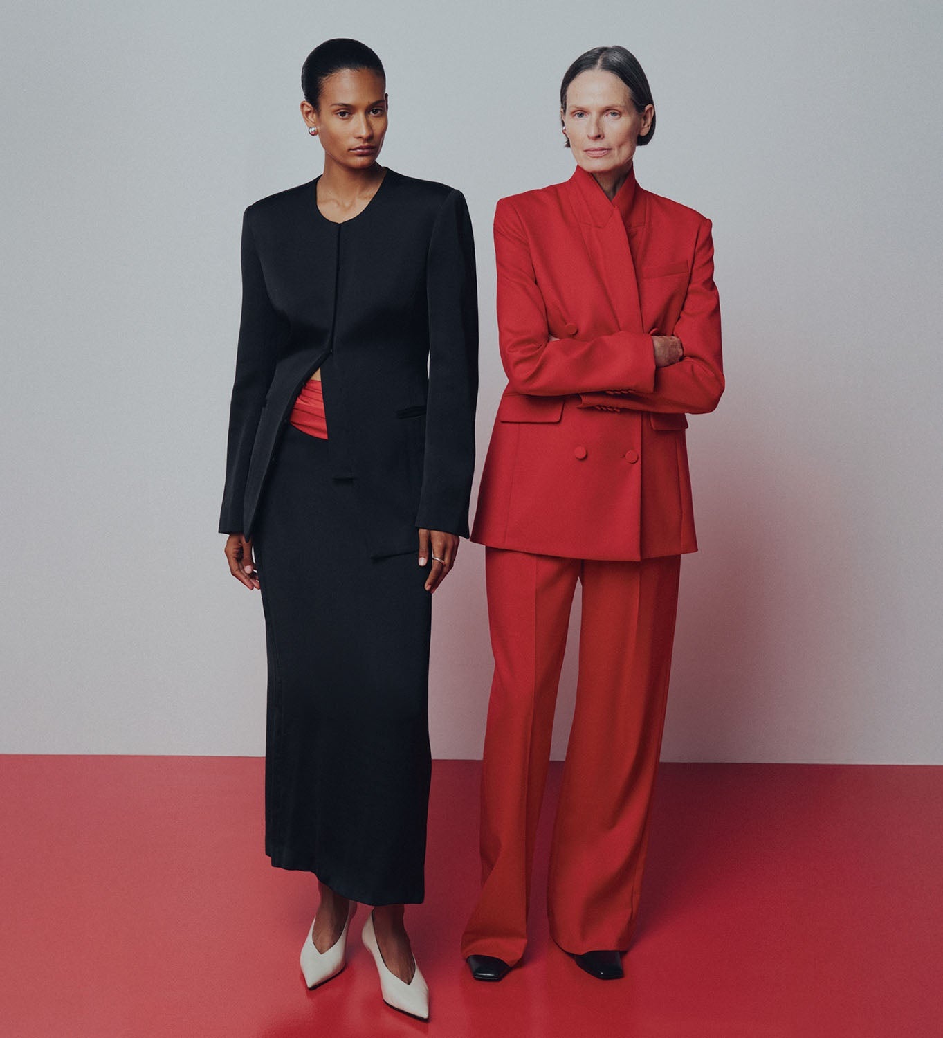 Two models wearing Argent tailoring in black and red