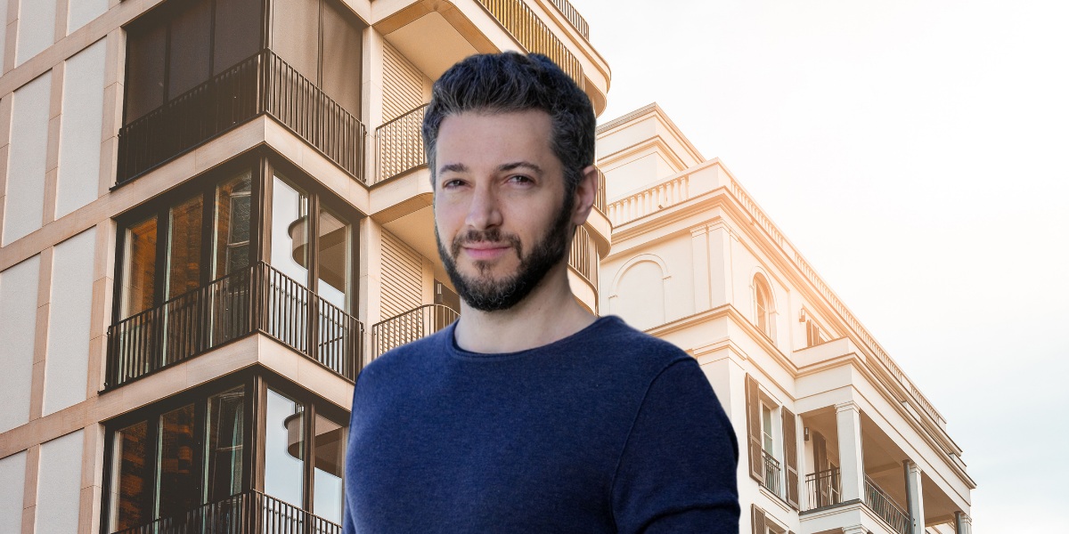 Arie Shpanya in a navy sweater, pictured against residential buildings in his 2022 interview