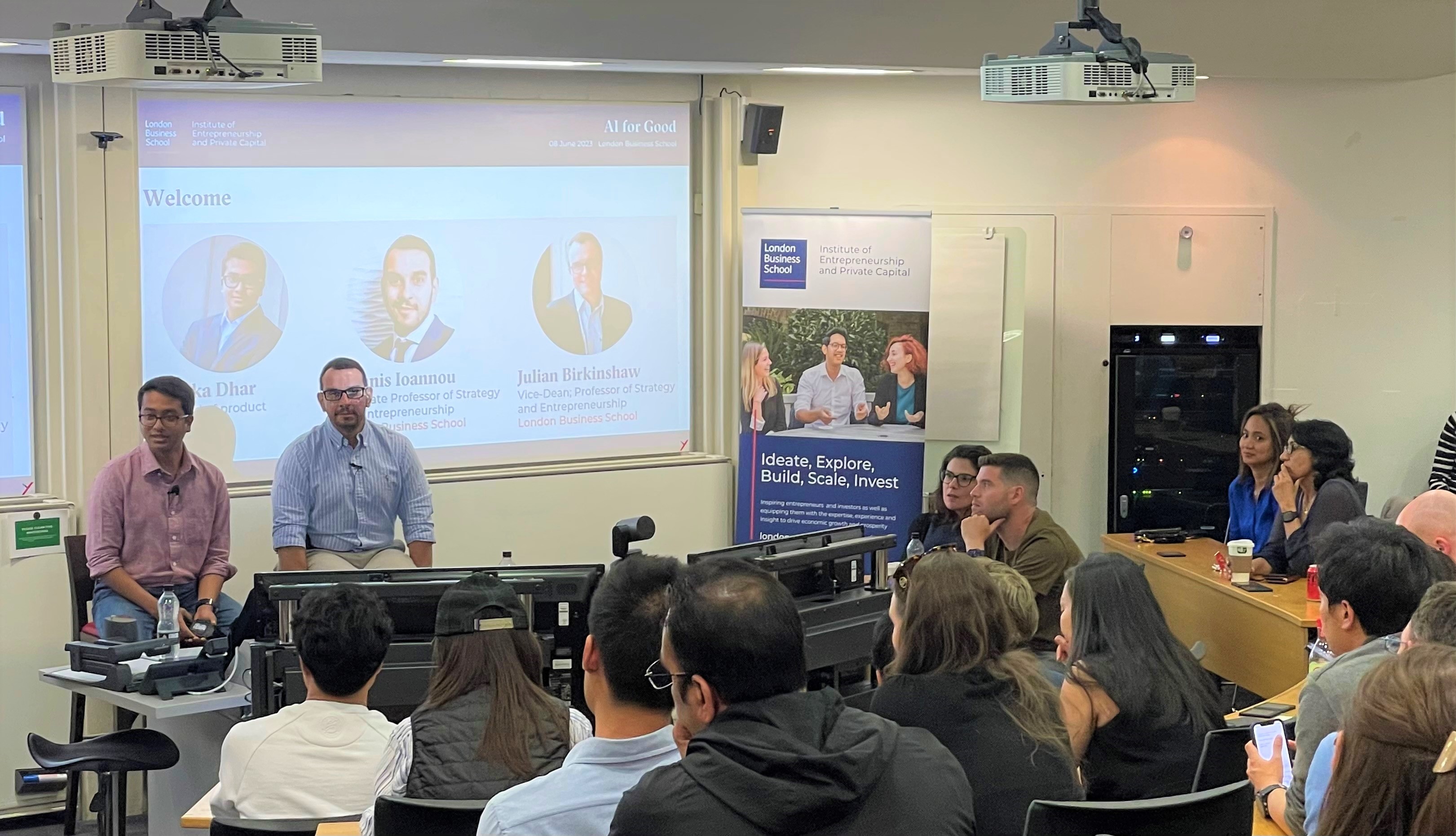 Arka Dhar seated at left beside Ioannis Ioannou during an AI for Good discussion at London Business School
