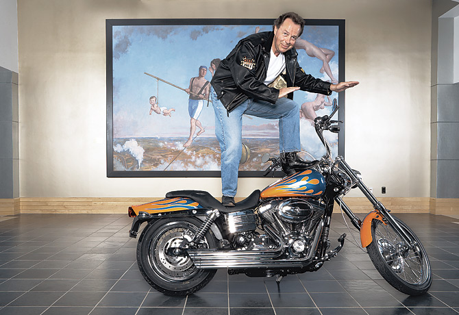 Arkadi Kuhlmann balancing on his flame-painted Harley-Davidson in ING DIRECT’s Wilmington lobby