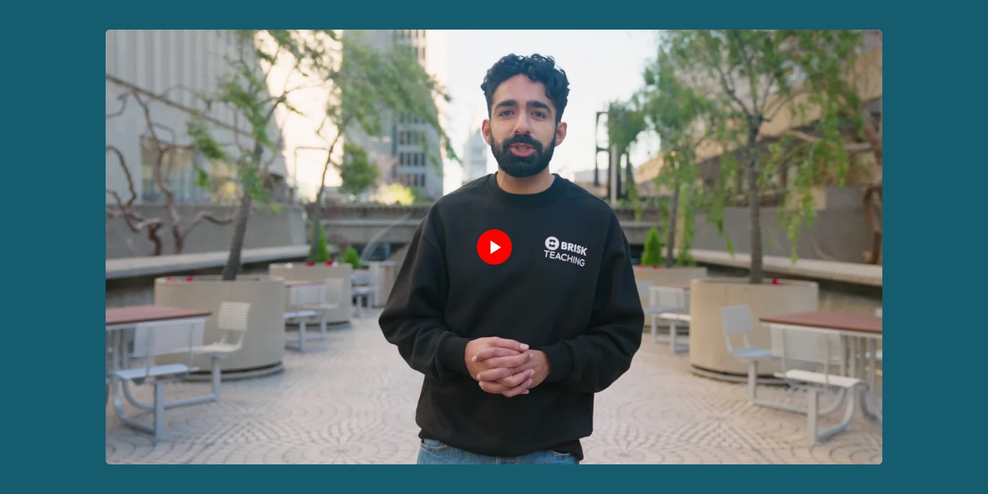 Arman Jaffer speaking in an outdoor courtyard during Brisk's Curriculum Intelligence announcement