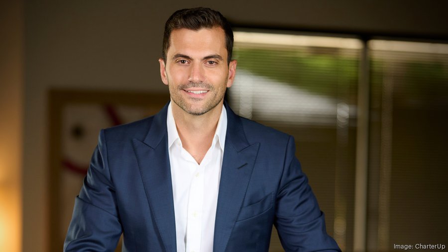 Armir Harris in a navy suit in an office setting
