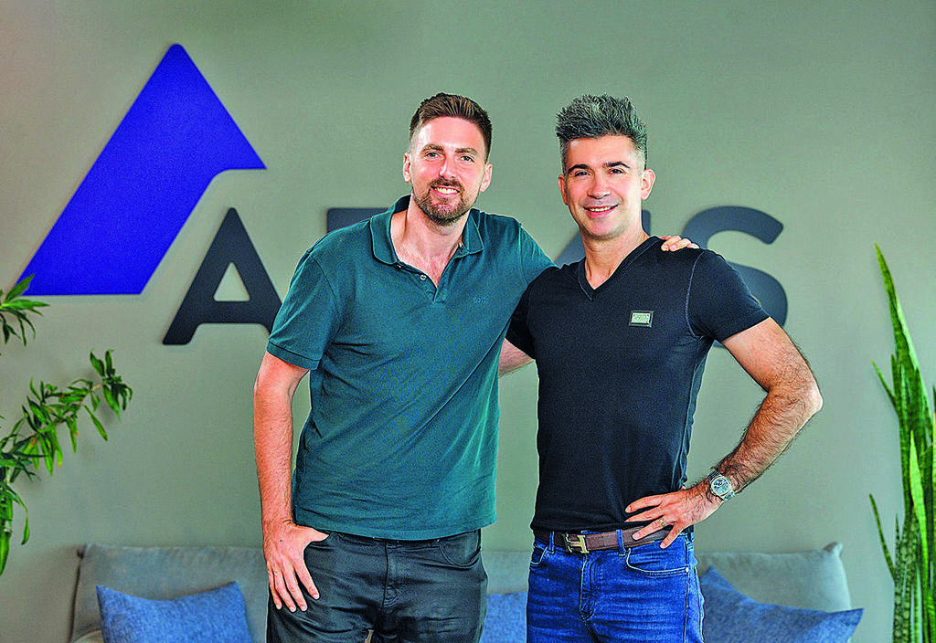 Armis co-founders Yevgeny Dibrov and Nadir Izrael standing together in an office