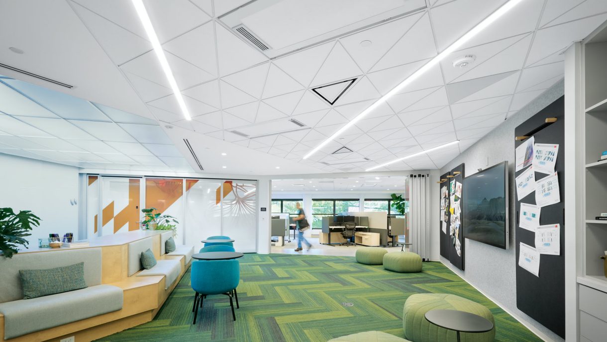 Work and collaboration areas beneath geometric ceiling panels at Armstrong’s Living Lab