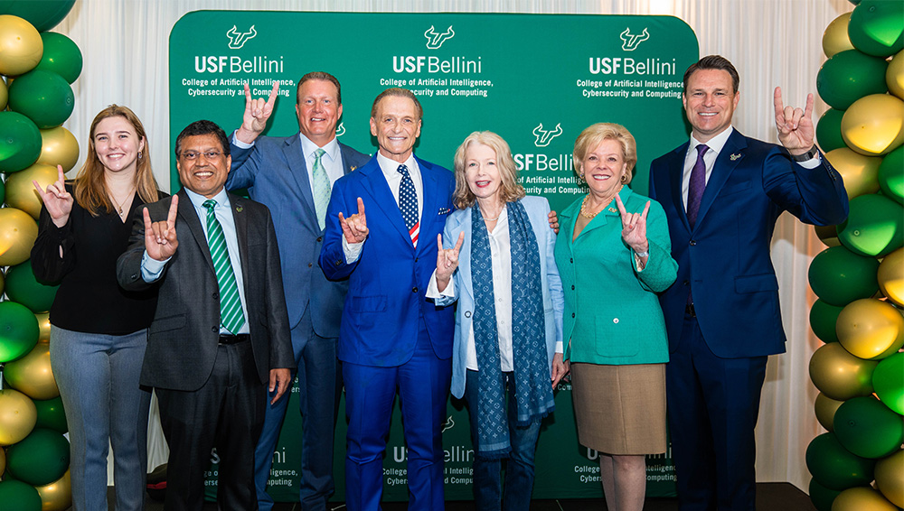 Arnie and Lauren Bellini stand with USF leaders and a cybersecurity student at the March 2025 college gift announcement