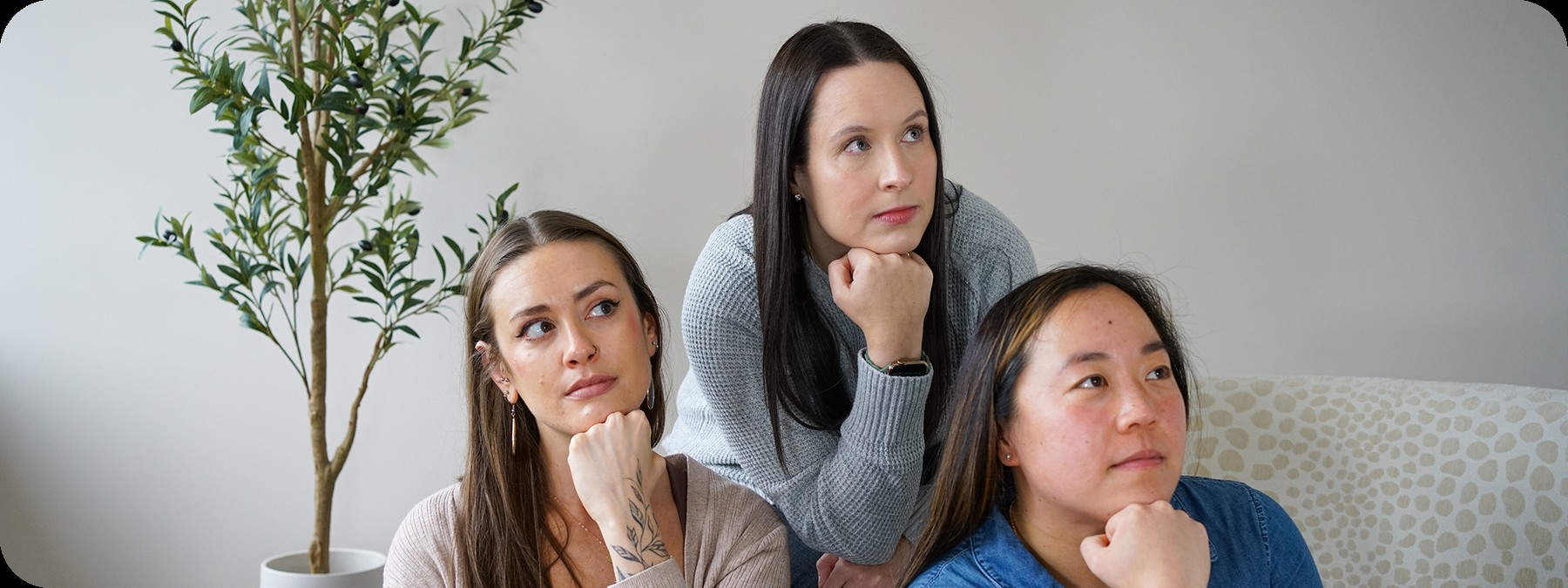 Three members of the Aroluxe team seated together in the agency office