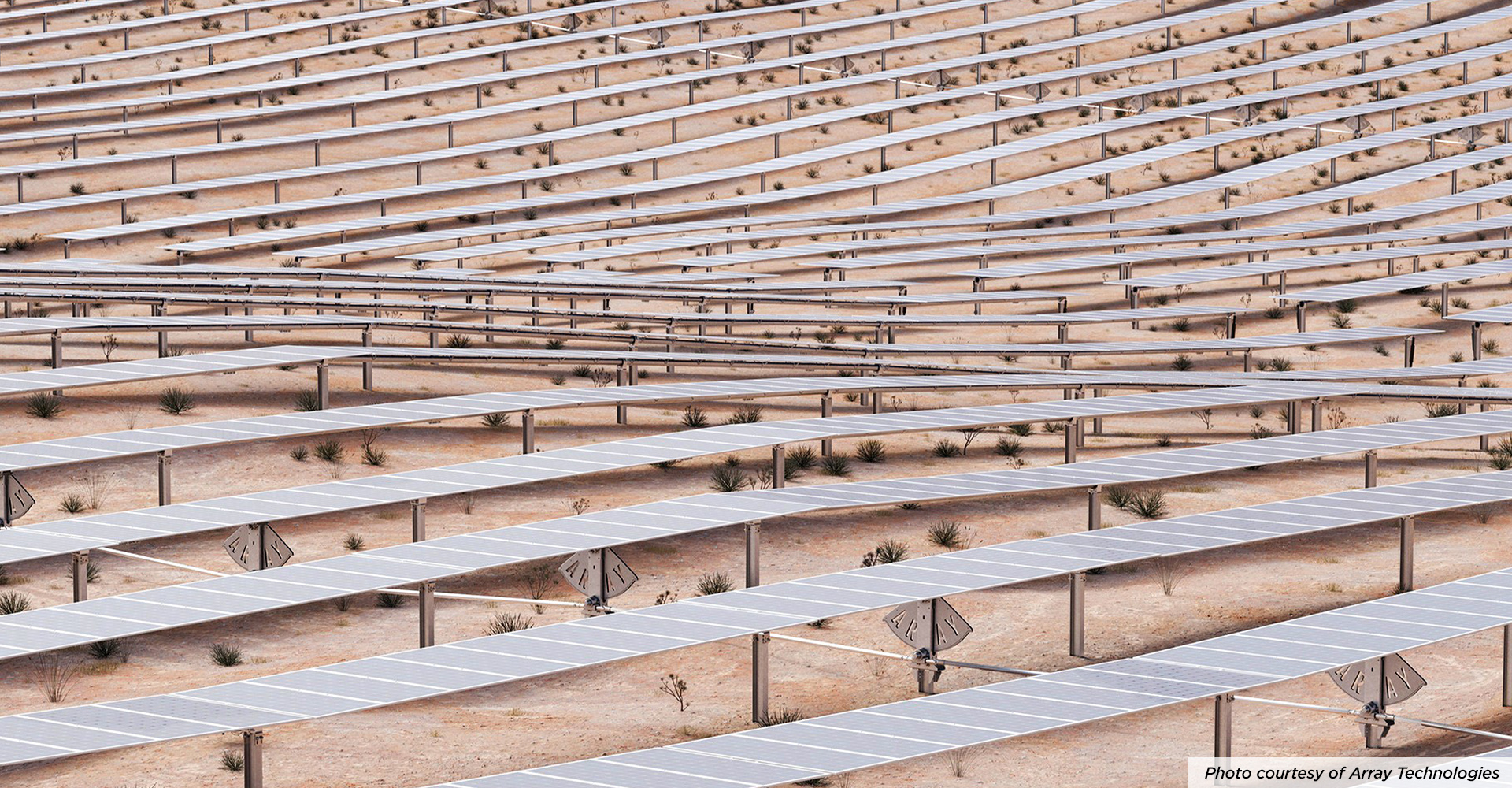 Rows of Array solar trackers following the contours of sandy terrain