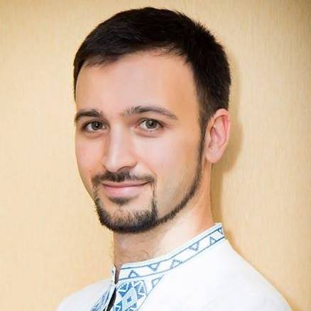 An archival photograph of Artem Mykhailiuk wearing a white embroidered shirt