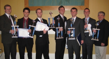 Six BYU information systems students and their adviser holding trophies after the 2011 national competition