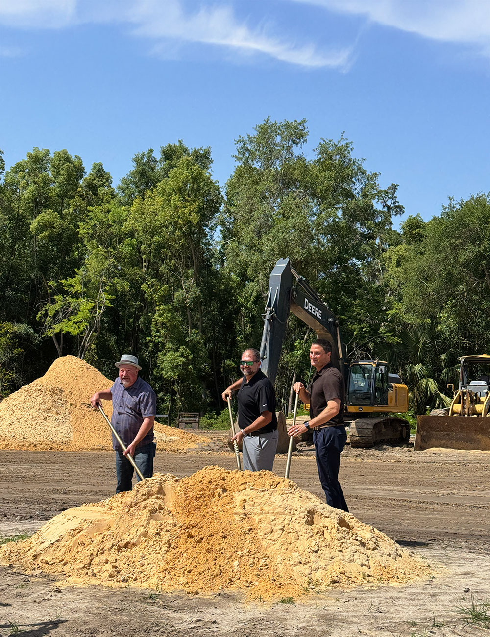Project stakeholders with ceremonial shovels at the Archer Place construction site