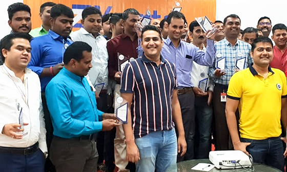 Kogta Financial colleagues gathered with trophies at the 2018 annual meeting in Silvassa