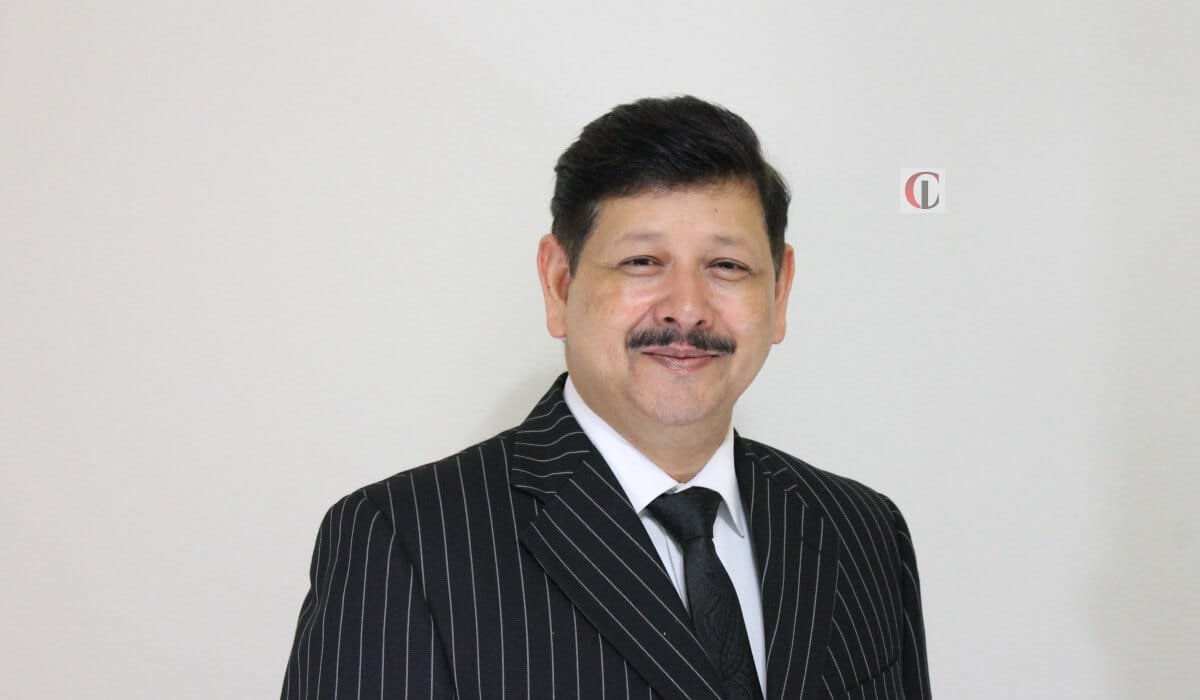 Arun K. Singh in a dark pinstripe suit against a light background