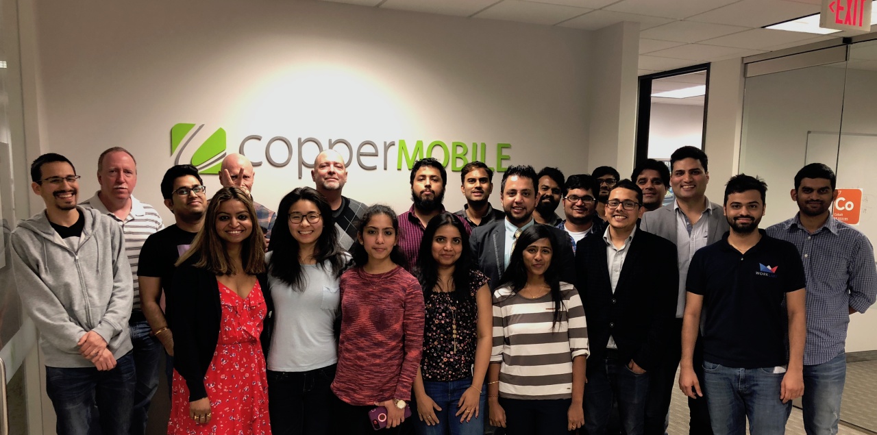 Copper Mobile colleagues gathered for a group photograph in the Dallas office
