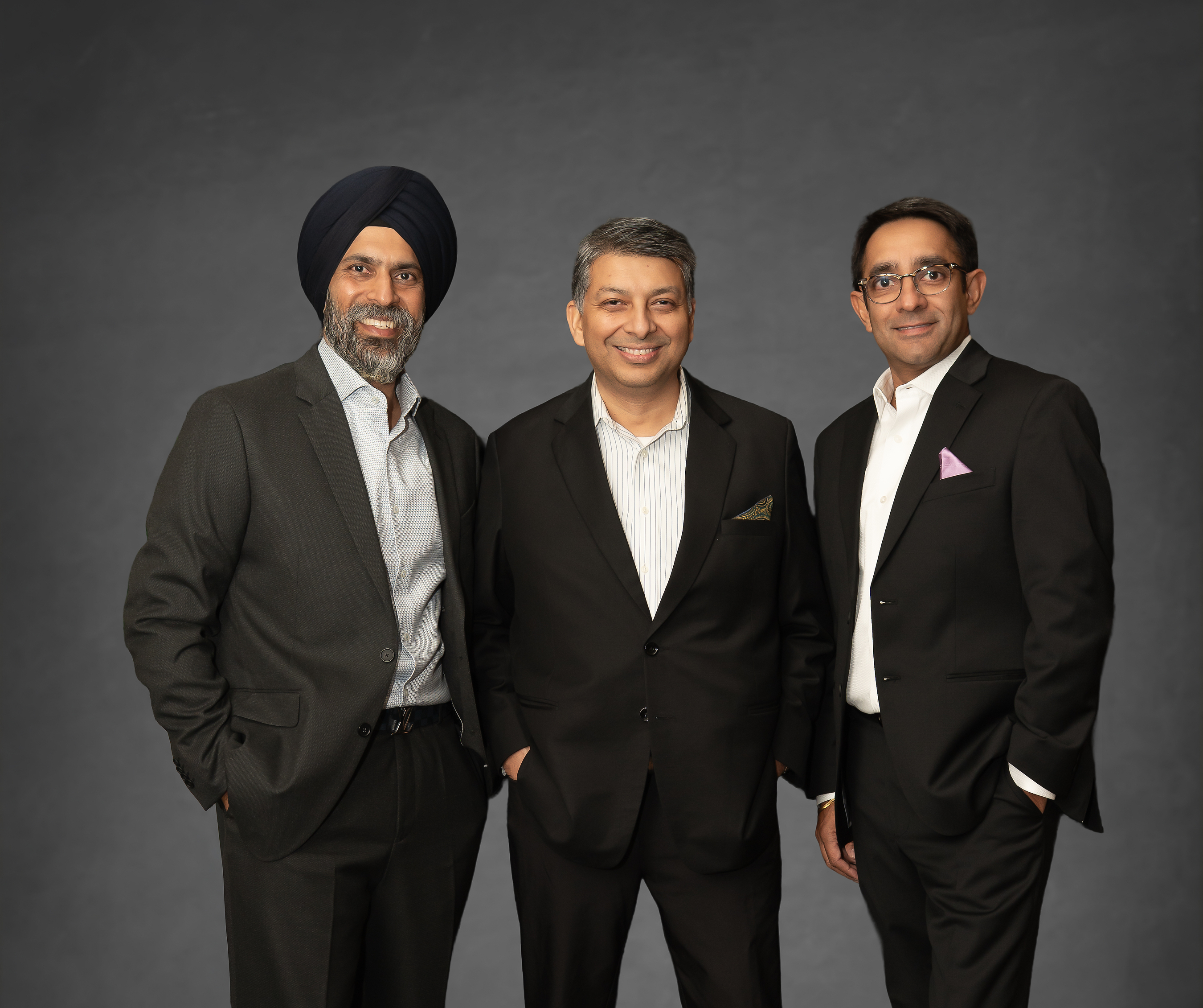AuxoAI co-founders Arvinder Pal Singh, Amaresh Tripathy, and Kabir Singh standing together.
