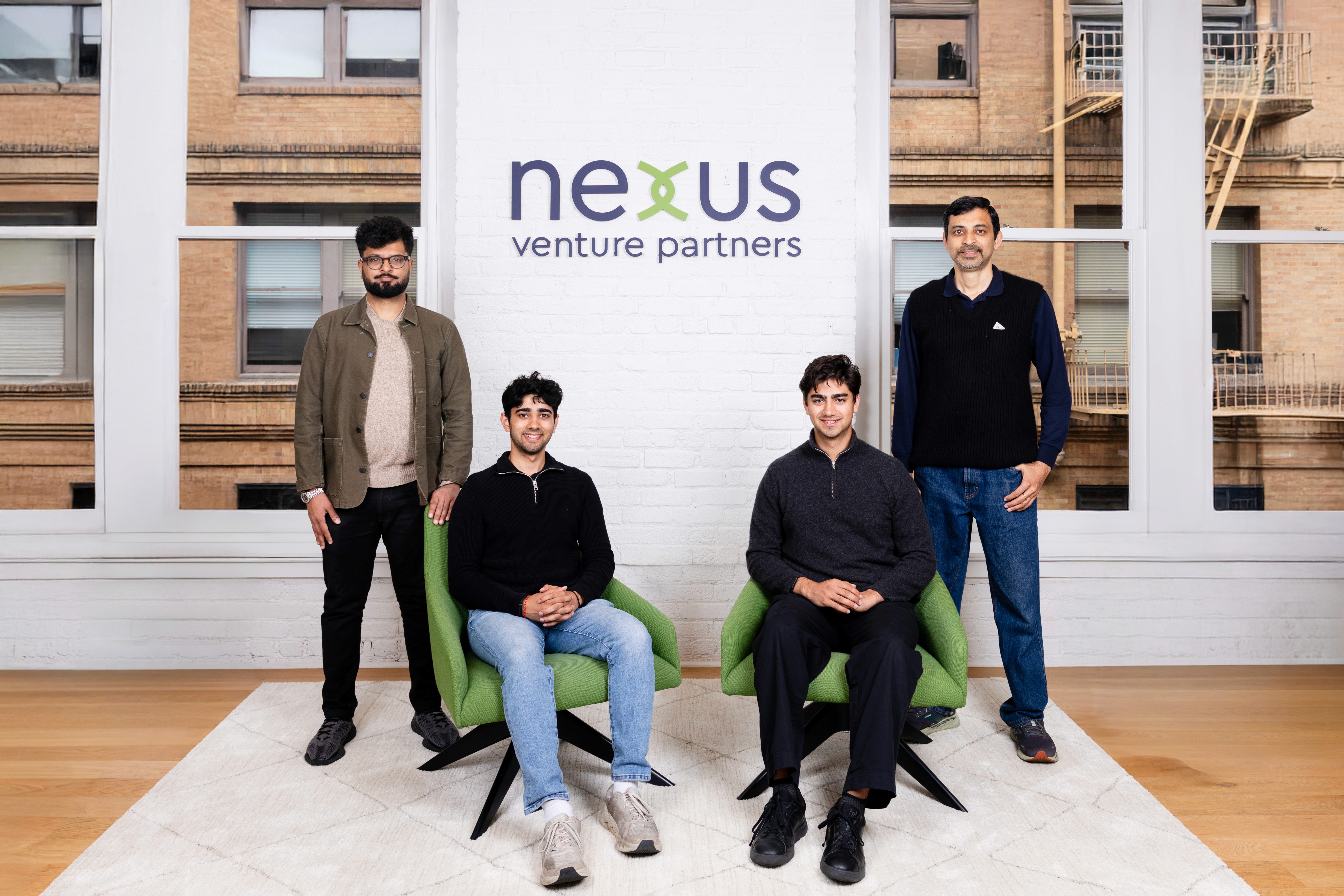 Contrario co-founders seated with members of the Nexus Venture Partners team in front of the Nexus office sign