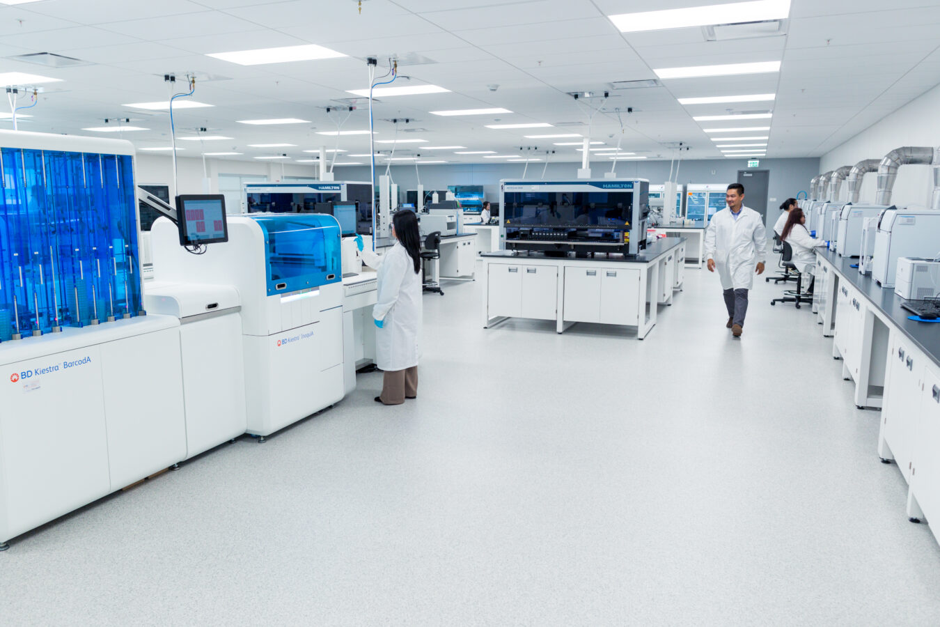 Ascend laboratory staff working among automated laboratory systems