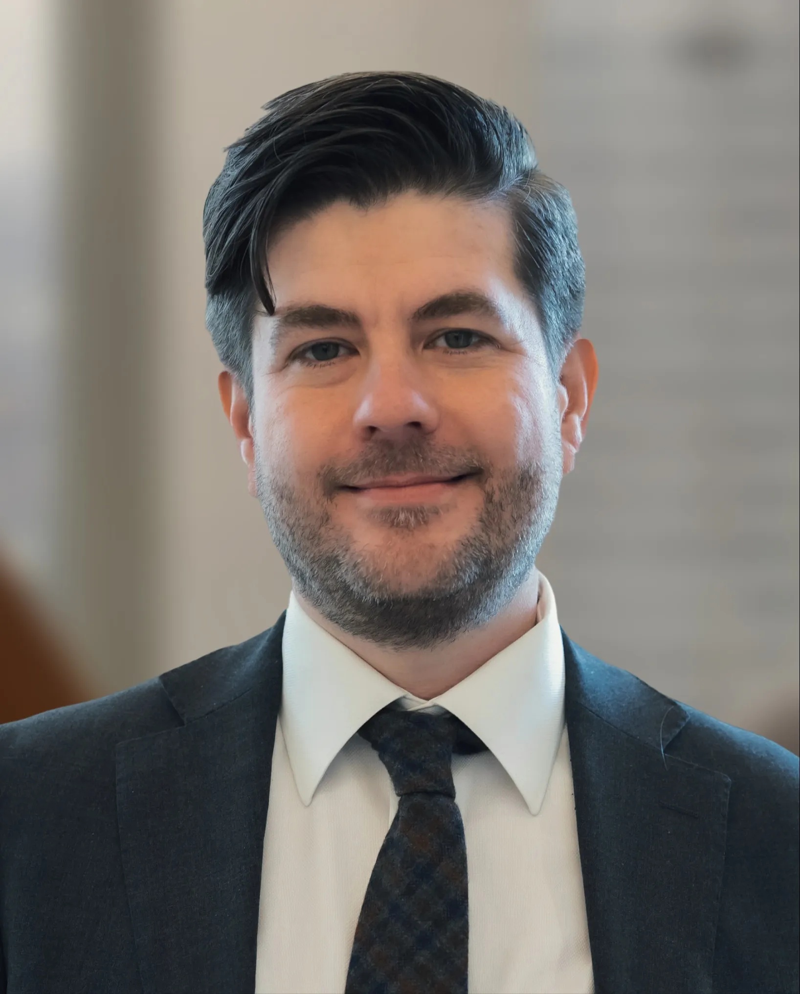 Ascertain CEO Mark Michalski wearing a dark suit and tie
