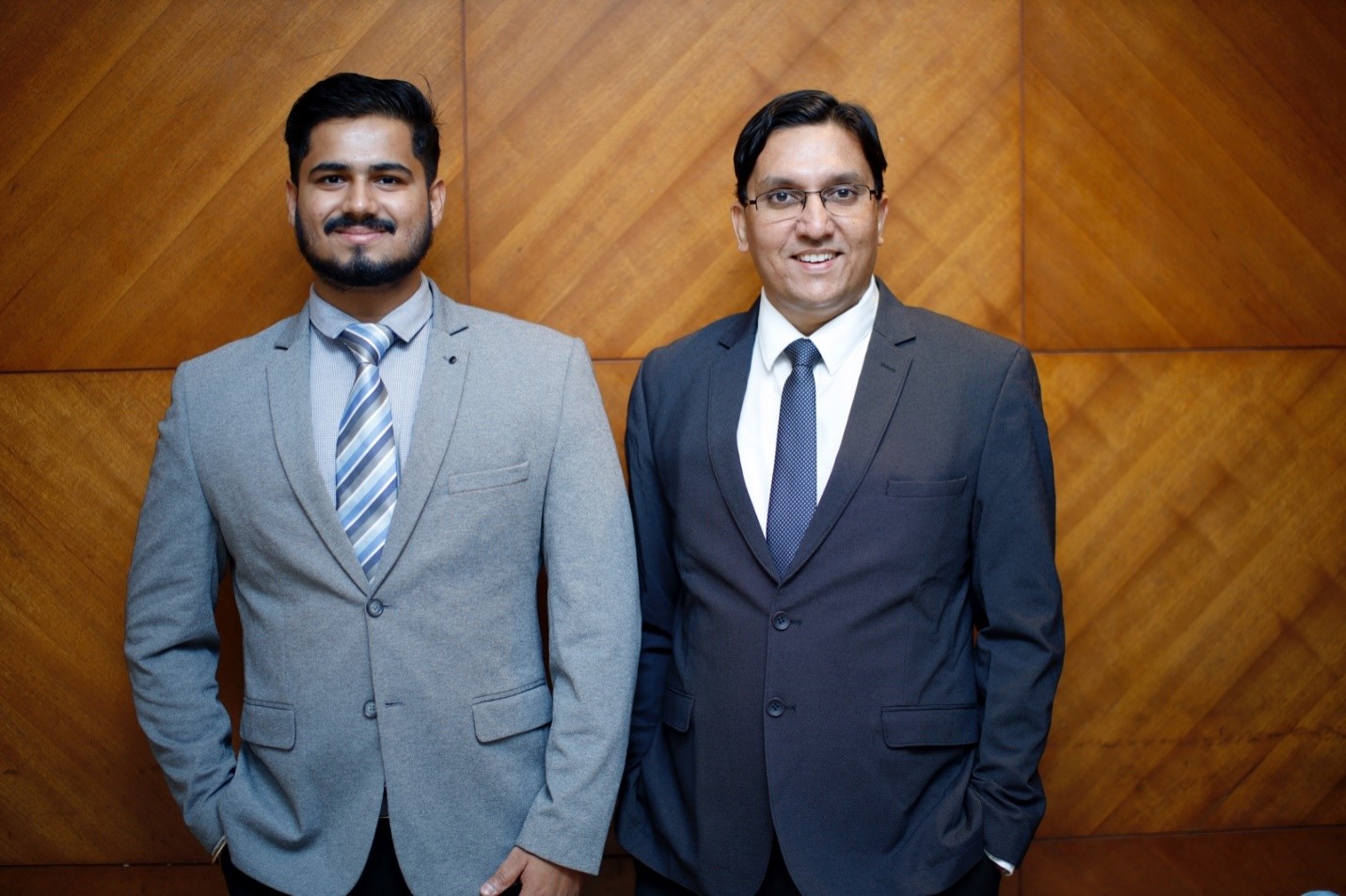 Tushar Shrivastava, left, and Ashish Narain Agarwal, right, standing together in suits