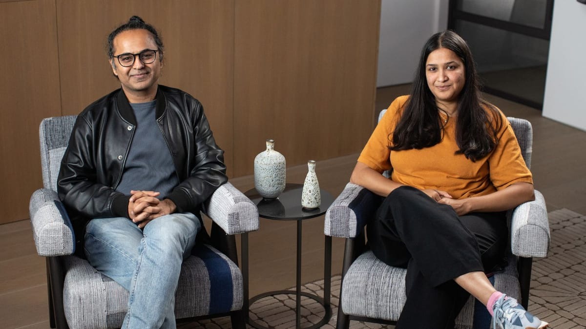 Ashish Vaswani and Niki Parmar seated together at a 2023 event