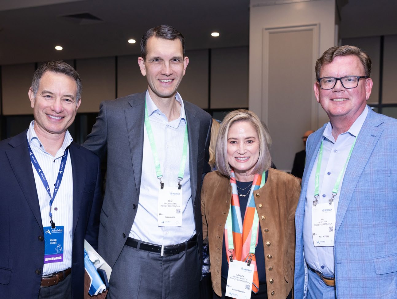 Ashley McEvoy, second from right, standing with three colleagues wearing conference badges.
