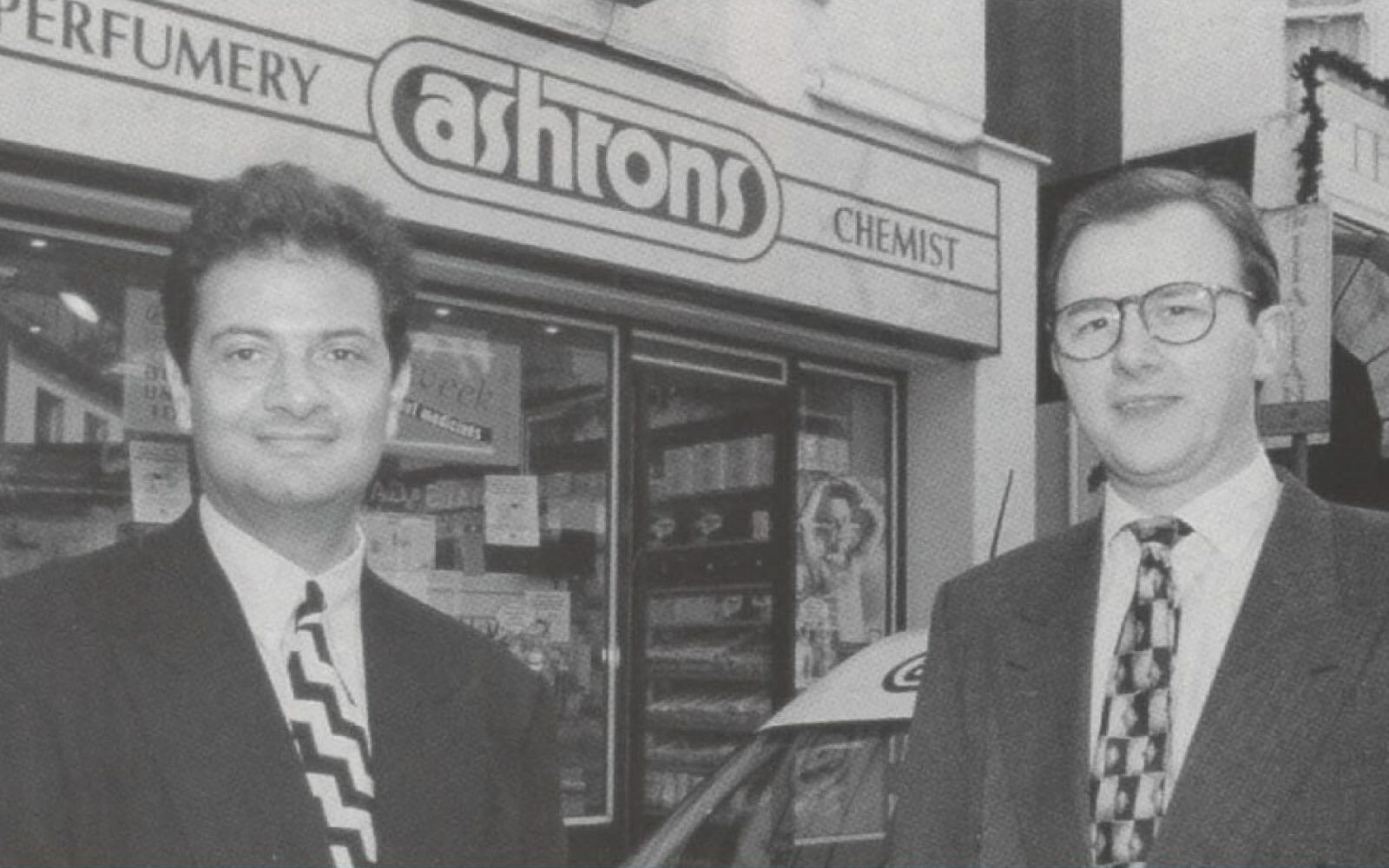 Archive photograph of Laurence Sprey and Martin England outside the original Ashtons community pharmacy