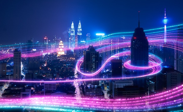Kuala Lumpur skyline threaded with long-exposure light trails