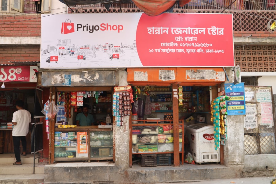 A neighbourhood general store with PriyoShop branding and stocked shelves