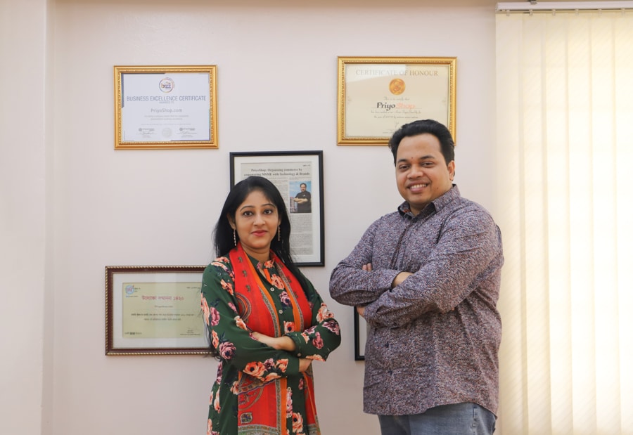 PriyoShop co-founders Dipty Mandal and Asikul Alam Khan standing together in an office