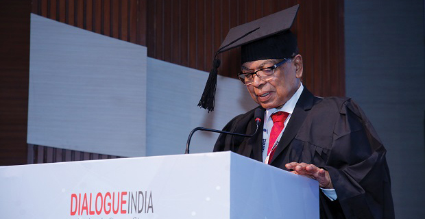 Asoke K. Laha speaks at a lectern wearing academic regalia