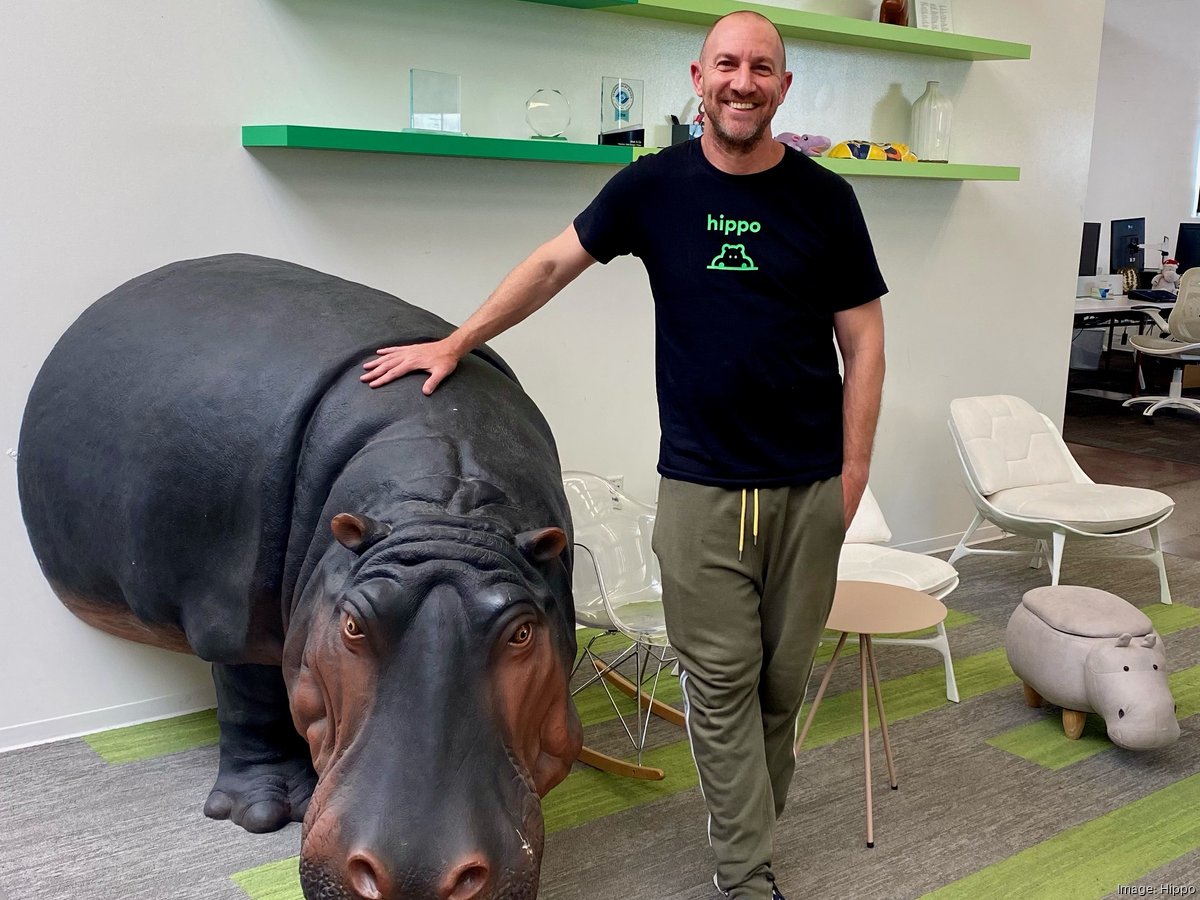 Assaf Wand beside a large hippo sculpture in the Hippo office