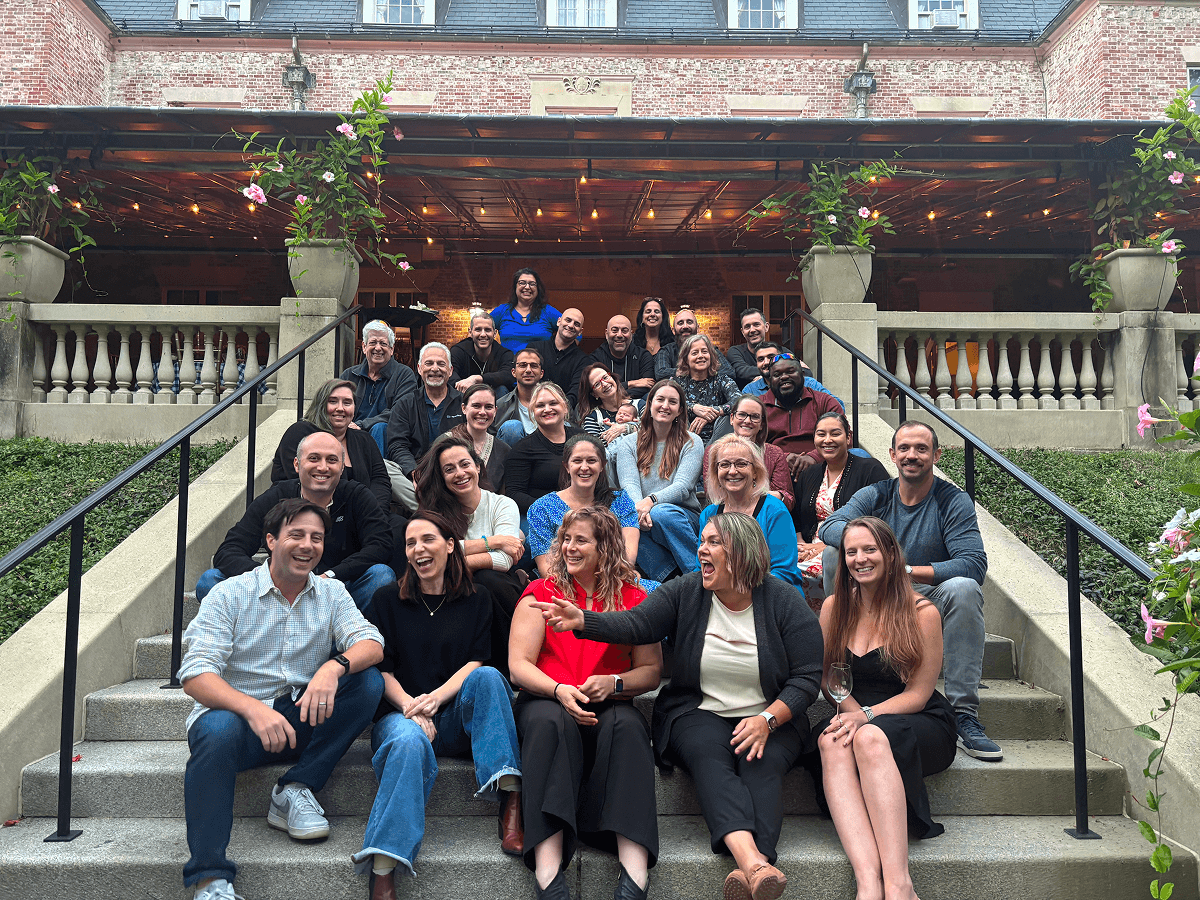 Assured Allies team gathered on outdoor steps