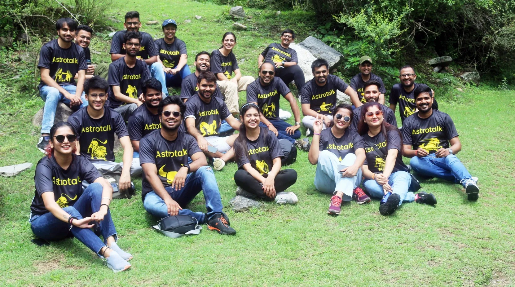 Astrotalk team members outdoors wearing matching zodiac T-shirts